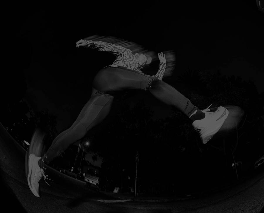 Athlete mid-leap in black and white
