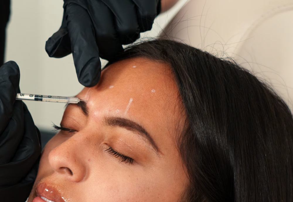 A nurse performing a facial treatment on a client